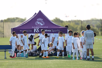 Fundación Real Madrid soccer camp players celebrating together