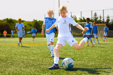 Players participating in Fundación Real Madrid soccer camp exercises